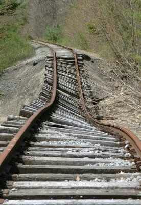 Collapsed roadbed beneath railroad tracks