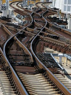 Complex railroad switch and crossover — multiple tracks converging and diverging at a rail yard