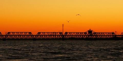 Sunset over BNSF railroad bridge over Missippi River at Fort Madison, Iowa
